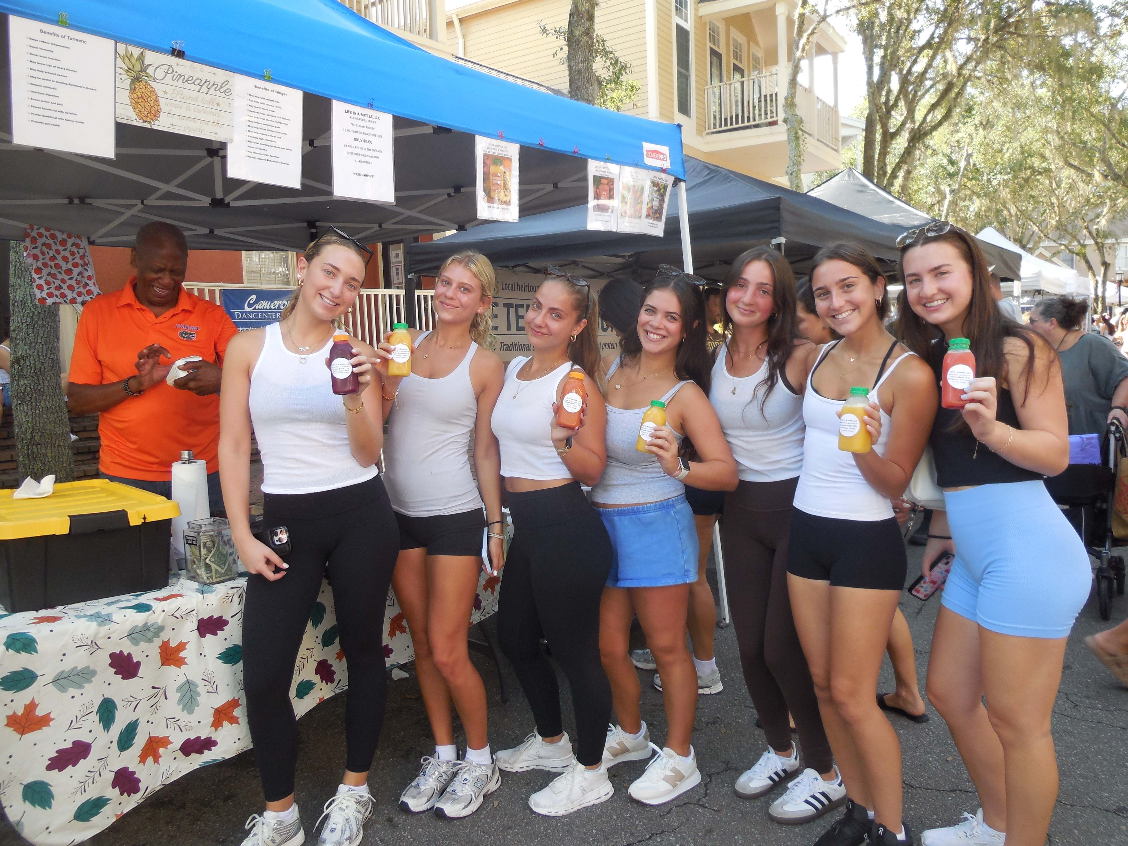 Group of customers at Life in a Bottle market booth